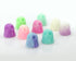 A selection of Giddy Ghost Glow 2-pack figurines from Bindlewood Shop—adorable, pastel-hued ghosts with big eyes—are displayed in neat rows on a white background. Available in shades of purple, blue, pink, green, and white, these figures sport cheerful expressions and some even glow in the dark.