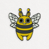 A whimsical, cartoon-style enamel Lemon Bee Pin of a cute "Lemon Bee" character designed by Amanda Louise Spayd, with large eyes and a friendly expression from Bindlewood Shop.