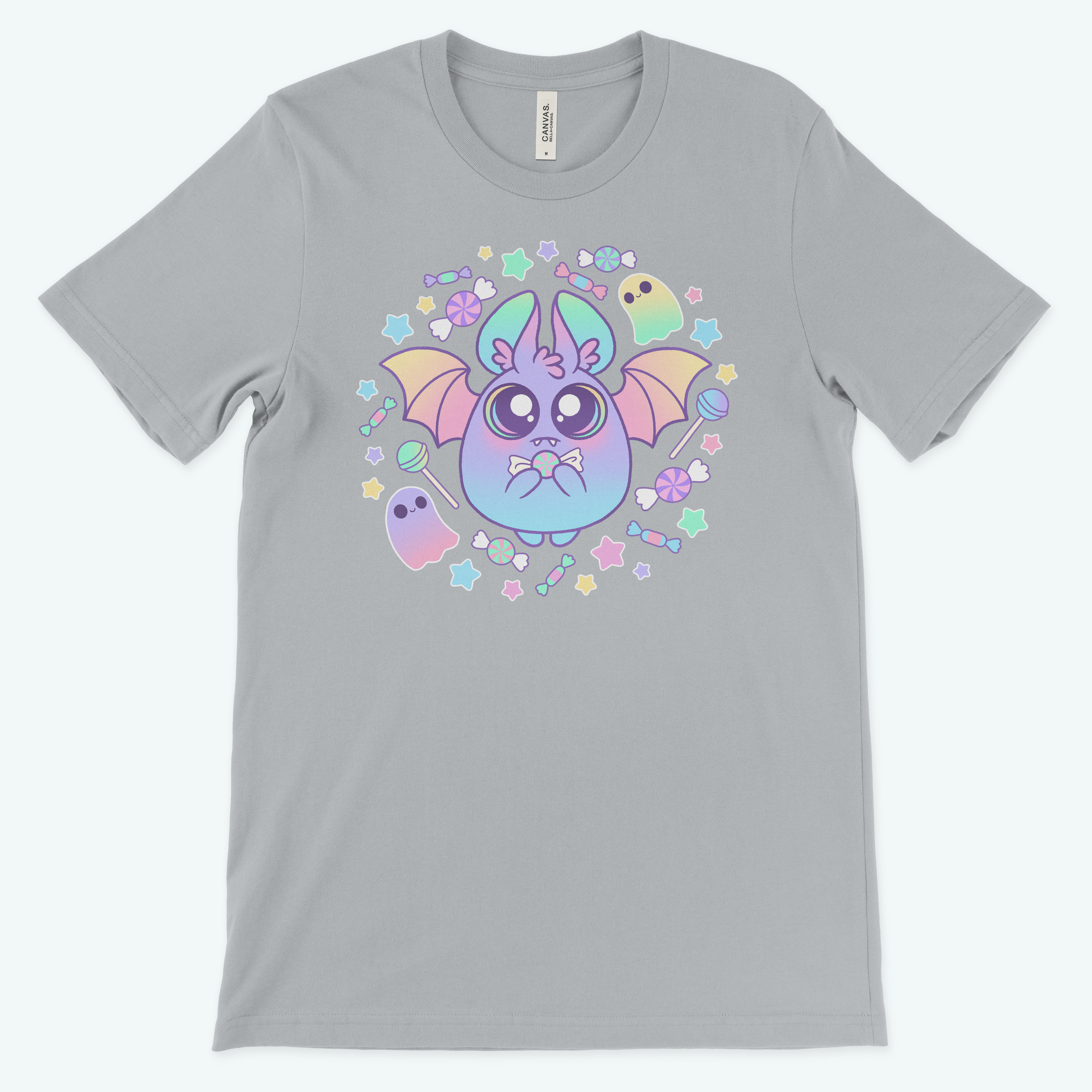 The Bindlewood Shop Pastel Candy Bat Tee is a gray, gender-neutral shirt with a whimsical cartoon bat and playful details like stars, candies, flowers, and ghosts.