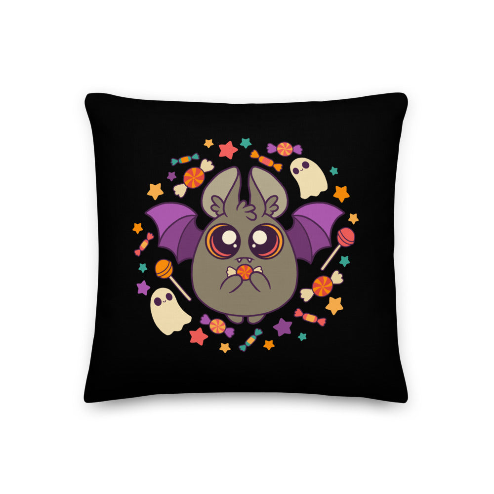 Introducing the Candy Bat Throw Pillow by Bindlewood Shop: a premium-feel black decorative pillow that features a cute, illustrated bat with purple wings holding a piece of candy. Surrounding the bat are colorful stars, candy, and two white cartoon ghosts, capturing the playful Halloween theme perfectly.