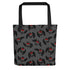 The Mothman Cryptid Tote by Bindlewood Shop is a gray bag with black handles, showcasing a pattern of cartoon-style black owls with red eyes and outspread wings. The background is dark gray, and the design evenly covers the entire surface, evoking the feel of cryptid-hunting gear or an Amanda Louise Spayd creation.