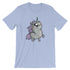 A light blue Goth Ponycorn Tee from Bindlewood Shop featuring a whimsical illustration of a chubby, wide-eyed unicorn with a purple mane and small wings. The unicorn stands upright with a happy expression, adding a playful and cute touch to the design. Made from high-quality fabric, it offers a comfortable, gender-neutral fit.
