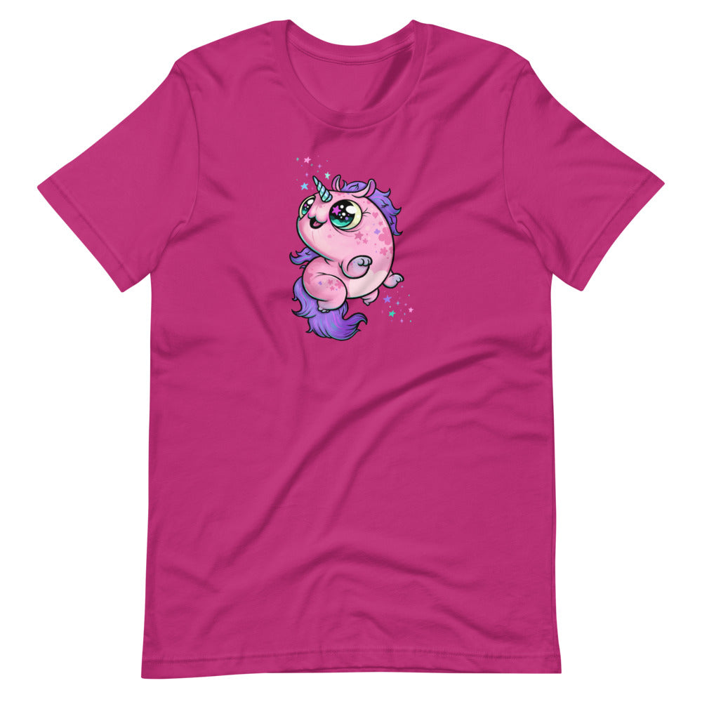 The Flooficorn Tee by Bindlewood Shop features a bright pink design with a cute, chubby unicorn—big green eyes, purple mane and tail, and tiny stars. This lightweight, gender-neutral shirt is perfect for any unicorn fan.