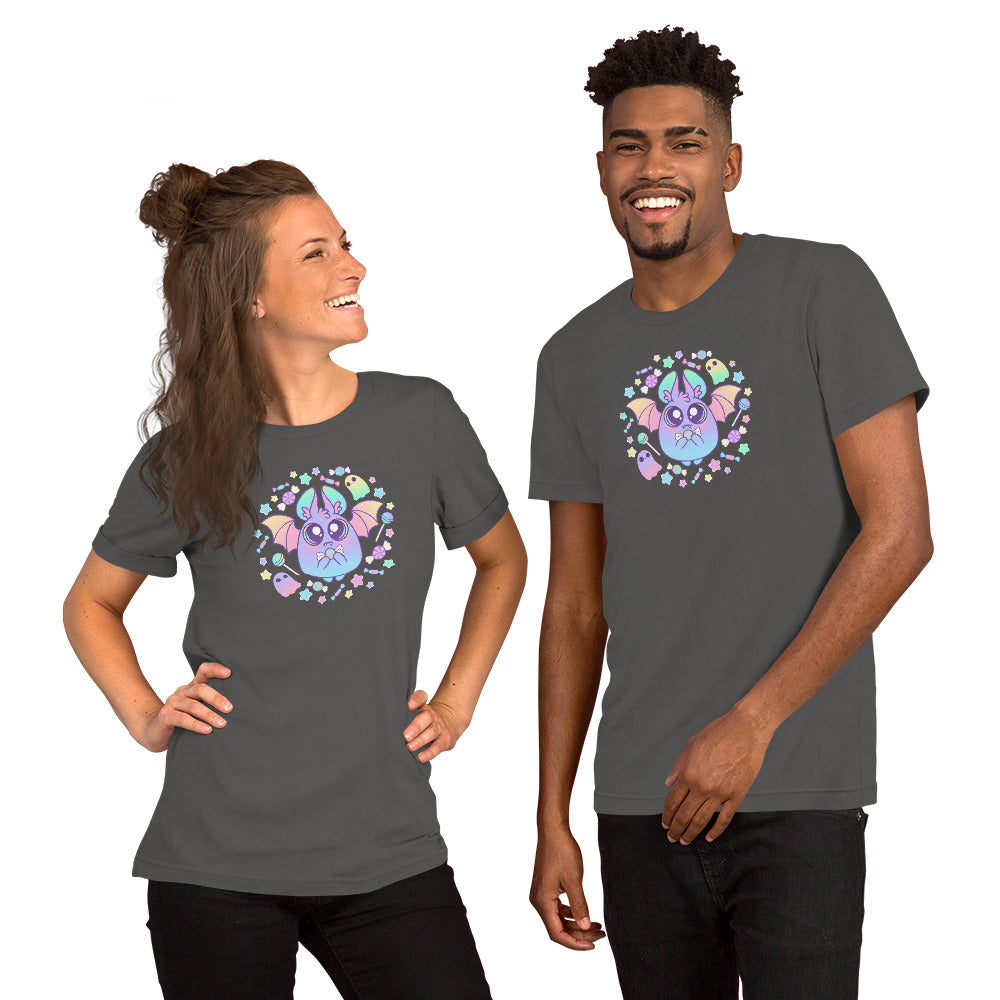 A woman and a man stand smiling, both wearing the Pastel Candy Bat Tee from Bindlewood Shop. The dark grey t-shirts feature a vibrant purple bat surrounded by stars and hearts. Designed to fit any gender comfortably with pre-shrunk fabric, they strike a relaxed pose with hands on hips, facing each other against a plain white background.
