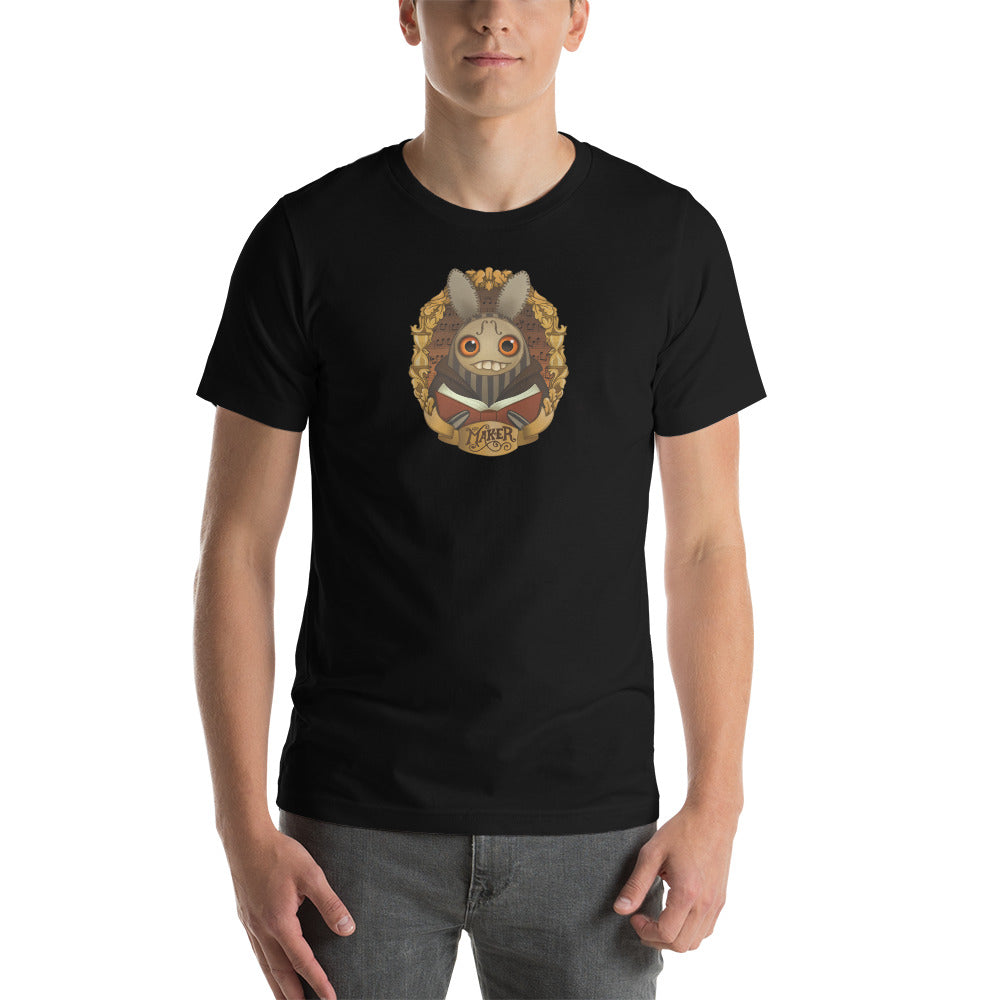 Man wearing a black t-shirt with a "The Maker" Tee by Bindlewood Shop animated character print on the front.