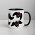 A ceramic Mothman Cryptid Mug from Bindlewood Shop with a black handle and interior, featuring a pattern of cartoonish owl-like creatures with red eyes and outspread wings. The mug is placed on a white surface against a neutral background, making it perfect for any cryptozoology researcher or fan of Amanda Louise Spayd.