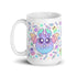 The Pastel Candy Bat Mug from Bindlewood Shop is a microwave-safe white ceramic mug. It showcases a cute, round, blue-purple bat with large eyes, small fangs, and pastel-colored wings. Surrounding the bat are colorful candies, stars, and playful ghost-like figures in a fun and whimsical design.